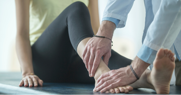 A doctor checking on a person's foot