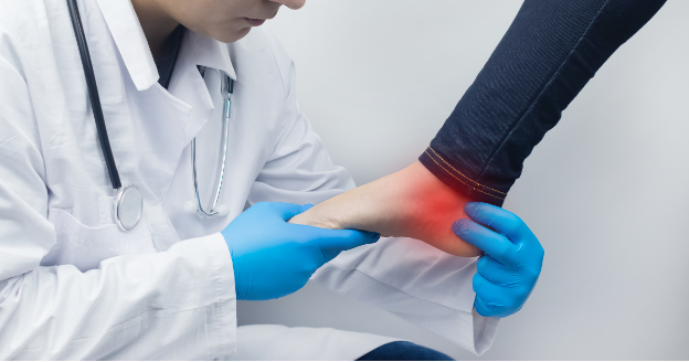 A doctor examining a patient with bottom of foot pain