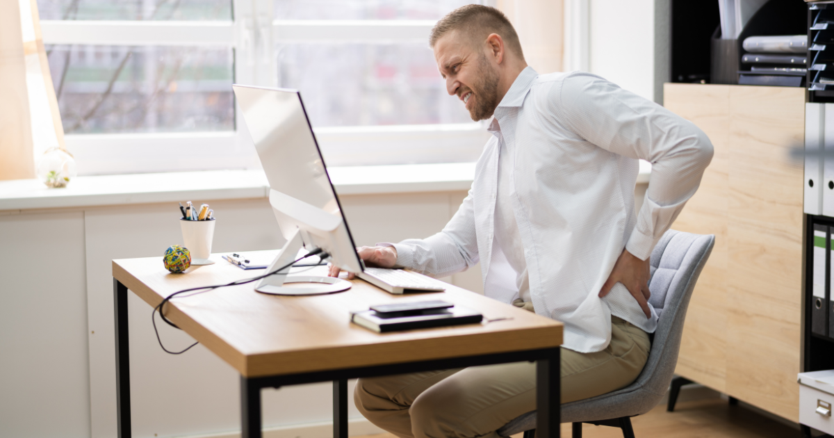 Man with hip pain at his desk