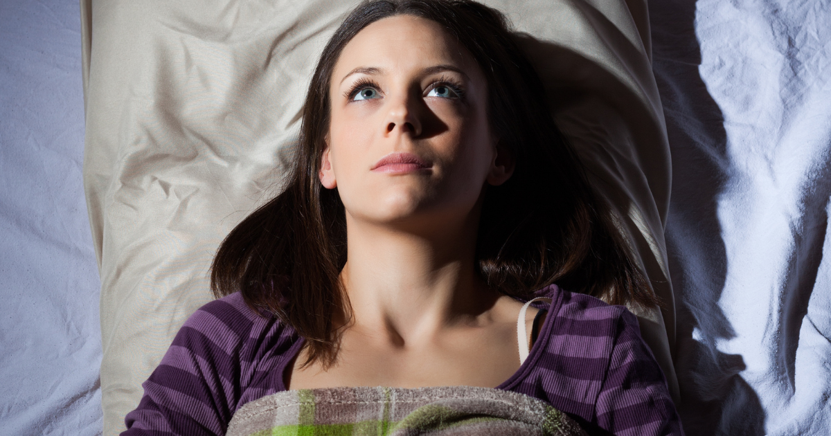 Woman restless in bed